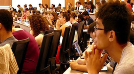 Graduate students sitting in a lecture hall looking forward