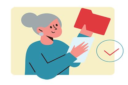 White woman with grey hair holds up a red file folder