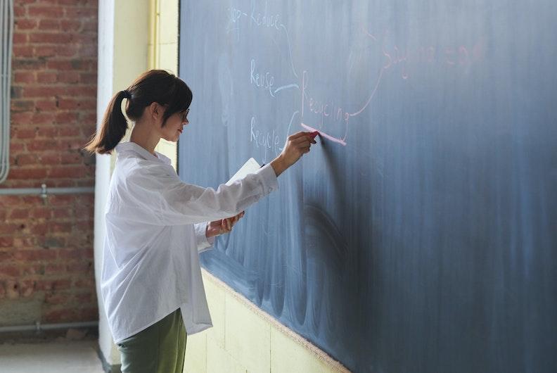 Woman writing on a blackboard