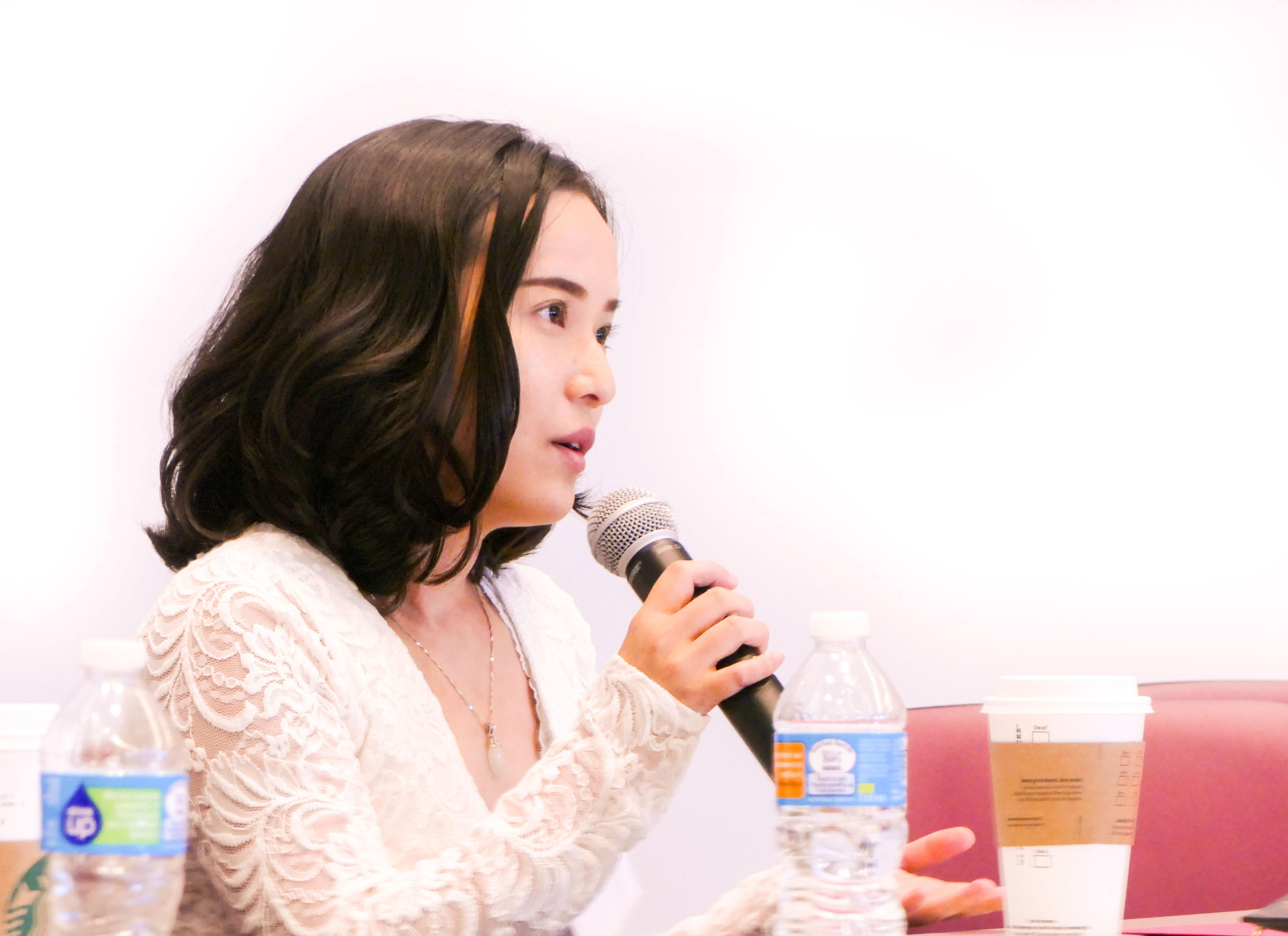 Woman speaking into a microphone