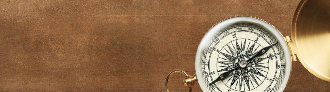 Brown paper background with a compass in the corner